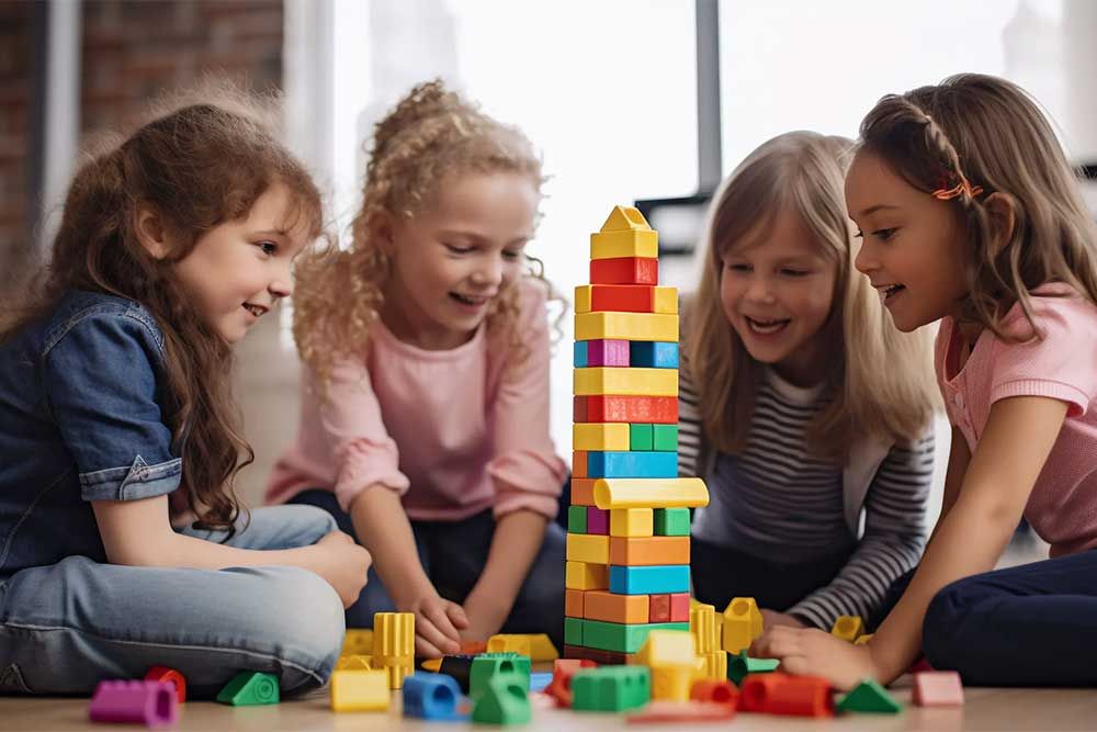 Young children playing together with colorful building blocks